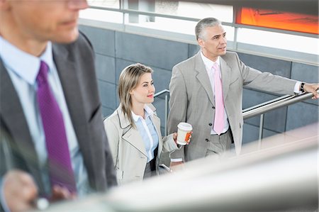 simsearch:693-08127175,k - Businesspeople walking up stairs in train station Fotografie stock - Premium Royalty-Free, Codice: 693-07912325