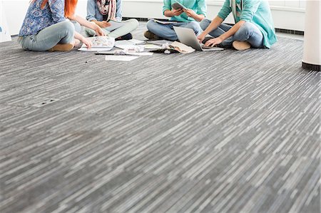 simsearch:693-07913007,k - Low section of businesspeople working on floor in creative office Stock Photo - Premium Royalty-Free, Code: 693-07912493