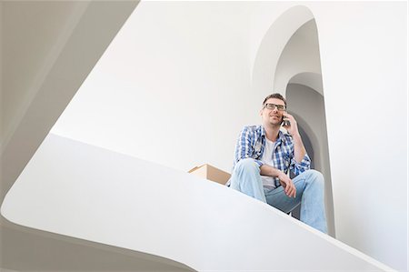 simsearch:693-07912604,k - Low angle view of man using cell phone in new home Photographie de stock - Premium Libres de Droits, Code: 693-07912639