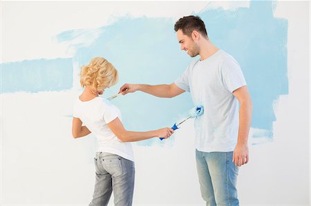 play fight - Playful couple painting each other in new house Stock Photo - Premium Royalty-Free, Code: 693-07912662