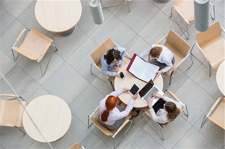 simsearch:6102-07602614,k - High angle view of businesswomen working in office canteen Stock Photo - Premium Royalty-Free, Code: 693-07912715