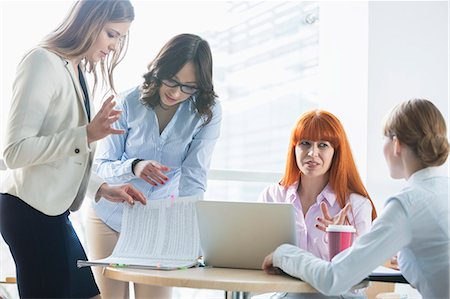 simsearch:400-04082460,k - Businesswomen discussing over documents at table in office Stock Photo - Premium Royalty-Free, Code: 693-07912737