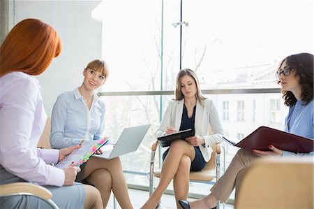 simsearch:6108-05868127,k - Businesswomen discussing in office Fotografie stock - Premium Royalty-Free, Codice: 693-07912739