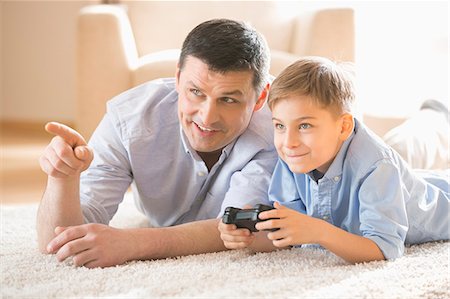simsearch:693-07542254,k - Father and son playing video game on floor at home Stock Photo - Premium Royalty-Free, Code: 693-07912808