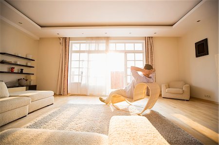 Rear view of man relaxing on modern chair at home Stockbilder - Premium RF Lizenzfrei, Bildnummer: 693-07912825