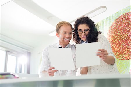 simsearch:693-07913057,k - Happy business colleagues examining samples in creative office Photographie de stock - Premium Libres de Droits, Code: 693-07912959