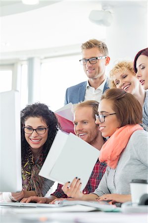 Business people using computer in creative office Stock Photo - Premium Royalty-Free, Code: 693-07913045