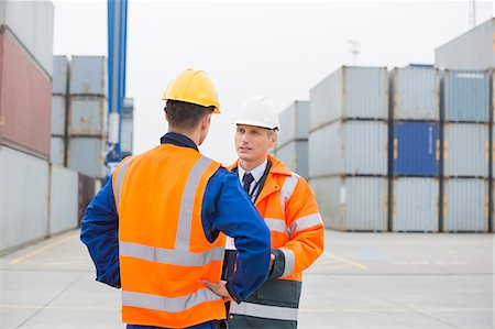 simsearch:693-07913158,k - Workers conversing in shipping yard Stock Photo - Premium Royalty-Free, Code: 693-07913074