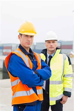 Portrait of confident worker standing with coworker in shipping yard Photographie de stock - Premium Libres de Droits, Code: 693-07913070