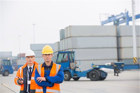 engineer standing with arms crossed - Portrait of confident workers standing in shipping yard Stock Photo - Premium Royalty-Free, Code: 693-07913073