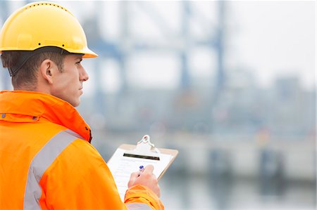 simsearch:693-07913181,k - Rear view of mid adult man writing on clipboard in shipping yard Stockbilder - Premium RF Lizenzfrei, Bildnummer: 693-07913081