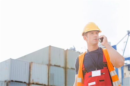 simsearch:693-07913158,k - Male worker using walkie-talkie in shipping yard Stock Photo - Premium Royalty-Free, Code: 693-07913137