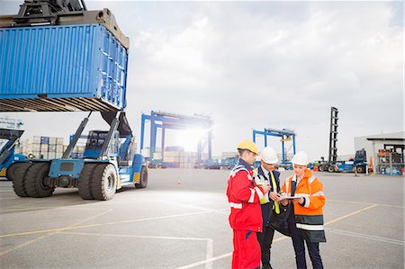 people economics - Workers discussing in shipping yard Stock Photo - Premium Royalty-Free, Code: 693-07913172