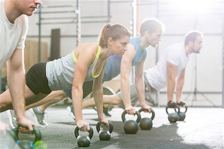 simsearch:693-08126948,k - Determined people doing pushups with kettlebells at crossfit gym Stock Photo - Premium Royalty-Free, Code: 693-08126953