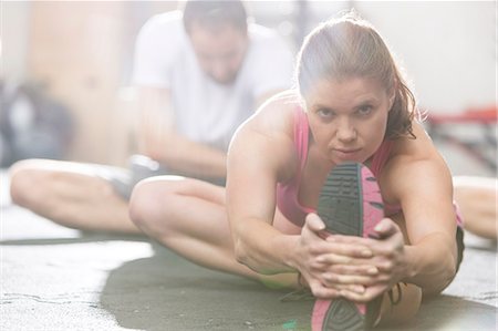 simsearch:693-08126948,k - Portrait of confident woman doing stretching exercise in crossfit gym Stock Photo - Premium Royalty-Free, Code: 693-08126966