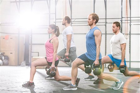 simsearch:693-08126934,k - Determined people lifting kettlebells at crossfit gym Stock Photo - Premium Royalty-Free, Code: 693-08126969