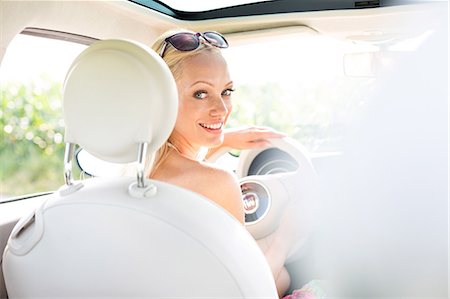 driving vehicle - Rear view portrait of happy woman driving car Stock Photo - Premium Royalty-Free, Code: 693-08127111