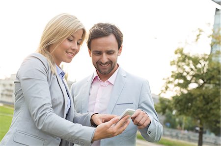 simsearch:693-06403498,k - Happy business couple using smart phone at park Stock Photo - Premium Royalty-Free, Code: 693-08127199
