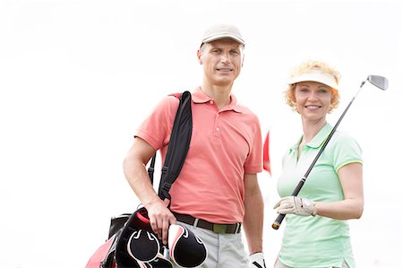 simsearch:693-06668077,k - Portrait of happy male and female golfers standing against clear sky Fotografie stock - Premium Royalty-Free, Codice: 693-08127238