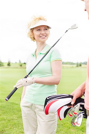 simsearch:693-06668077,k - Happy woman looking at male friend at golf course Fotografie stock - Premium Royalty-Free, Codice: 693-08127233