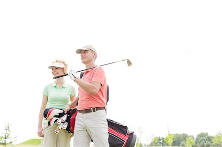 simsearch:693-06668077,k - Low angle view of smiling golfers standing against clear sky Fotografie stock - Premium Royalty-Free, Codice: 693-08127244