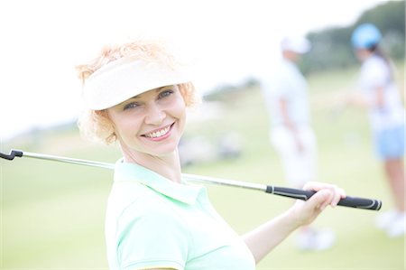 simsearch:693-08127270,k - Portrait of happy female golfer holding golf club Foto de stock - Sin royalties Premium, Código: 693-08127252