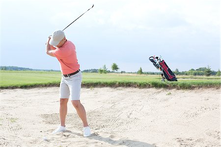 simsearch:6122-07694525,k - Man swinging at golf course against sky Stock Photo - Premium Royalty-Free, Code: 693-08127268