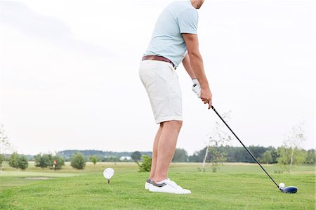 simsearch:6122-07694533,k - Low section side view of man playing golf against clear sky Stock Photo - Premium Royalty-Free, Code: 693-08127289