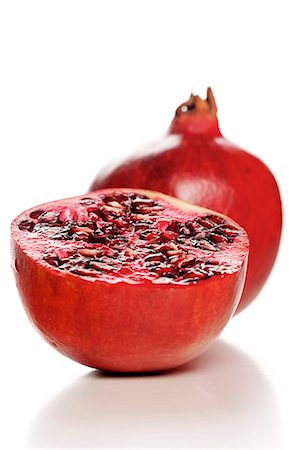 fruits and grains and white background - Studio shot of pomegranate fruit Stock Photo - Premium Royalty-Free, Code: 693-08127362