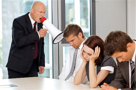 Young confident caucasian businessman screaming on his employee Stock Photo - Premium Royalty-Free, Code: 693-08127604