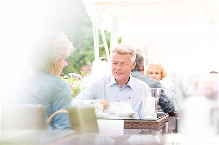 parasol - Middle-aged couple sitting at sidewalk cafe on sunny day Stock Photo - Premium Royalty-Free, Code: 693-08127685