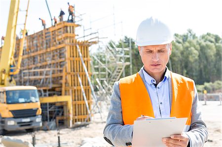 supervisor (hombre) - Supervisor writing on clipboard at construction site Photographie de stock - Premium Libres de Droits, Code: 693-08127794