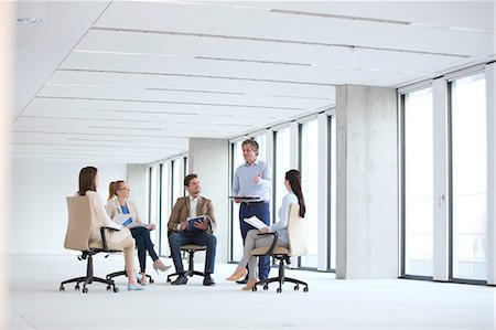 simsearch:632-05603831,k - Mature businessman discussing with colleagues sitting on chair in new office Stockbilder - Premium RF Lizenzfrei, Bildnummer: 693-08769273