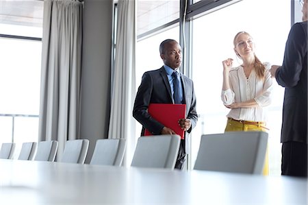 simsearch:693-08769289,k - Business people having discussion while standing by conference table in office Stock Photo - Premium Royalty-Free, Code: 693-08769280