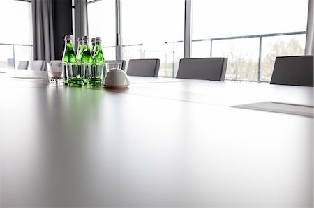 simsearch:695-05771864,k - Water bottles and drinking glasses on conference table in office Stock Photo - Premium Royalty-Free, Code: 693-08769351