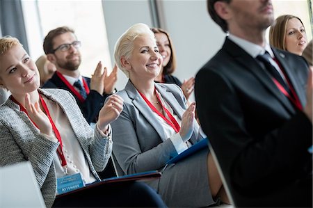 Happy business people applauding during seminar Stock Photo - Premium Royalty-Free, Code: 693-08769385