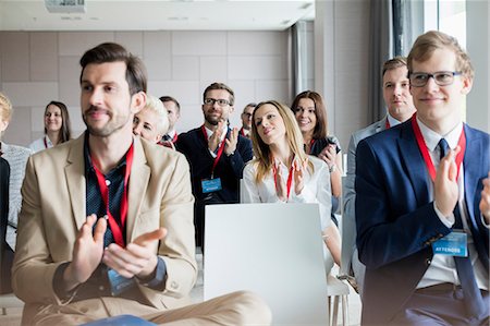 simsearch:693-08769401,k - Confident business people applauding during seminar Stock Photo - Premium Royalty-Free, Code: 693-08769412