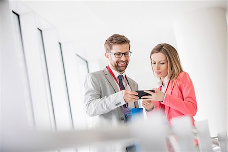 simsearch:693-08769446,k - Business people using smart phone in convention center Stock Photo - Premium Royalty-Free, Code: 693-08769465