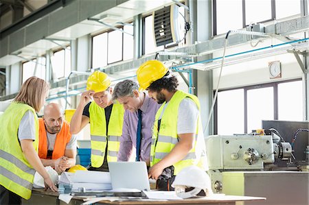 simsearch:693-06379749,k - Male architect and manual workers discussing over blueprints in industry Stock Photo - Premium Royalty-Free, Code: 693-08769521