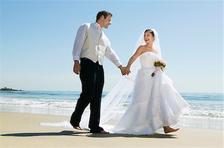 simsearch:693-03686309,k - Bride and Groom walking on beach Stock Photo - Premium Royalty-Free, Code: 693-03299473