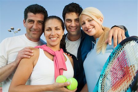 simsearch:693-03565397,k - Four mixed doubles tennis players by net at tennis court, portrait Stock Photo - Premium Royalty-Free, Code: 693-03299492