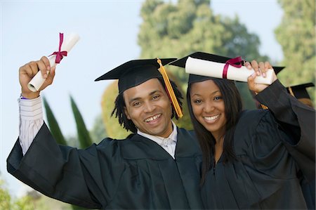 simsearch:693-06014222,k - Two graduates hoisting diplomas outside, portrait Stock Photo - Premium Royalty-Free, Code: 693-03299532
