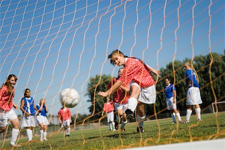 soccer teenage girls kick - Girl (13-17) scoring with soccer ball Stock Photo - Premium Royalty-Free, Code: 693-03299567