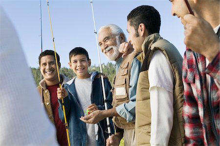 simsearch:694-03318999,k - Male members of three generation family holding fishing rods outdoors, smiling Fotografie stock - Premium Royalty-Free, Codice: 693-03299583