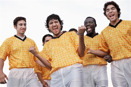 Cheering soccer team, portrait, low angle view Stock Photo - Premium Royalty-Free, Code: 693-03299625