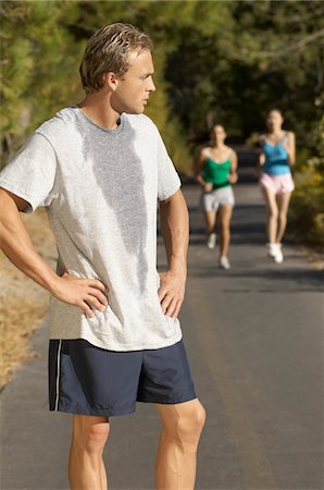 Male jogger pausing for breath on path Stock Photo - Premium Royalty-Free, Code: 693-03299692