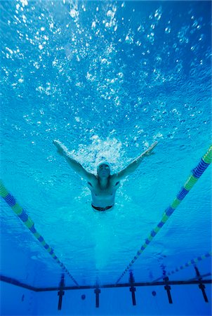 Man Swimming in Pool Stock Photo - Premium Royalty-Free, Code: 693-03299714