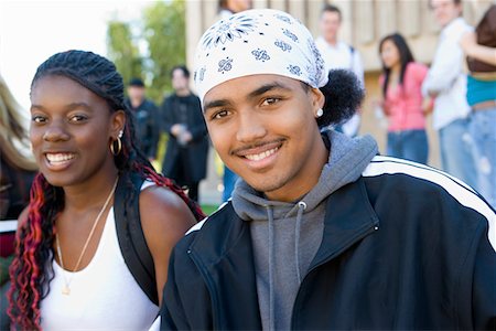 Two students smiling outdoors, (portrait) Stock Photo - Premium Royalty-Free, Code: 693-03299777