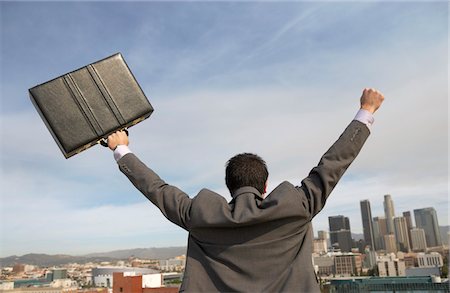 superhero back view - Business man cheering to city, back view Stock Photo - Premium Royalty-Free, Code: 693-03299850