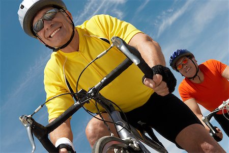 simsearch:693-06015367,k - Two men on bicycle ride, portrait, low angle view Stock Photo - Premium Royalty-Free, Code: 693-03299881
